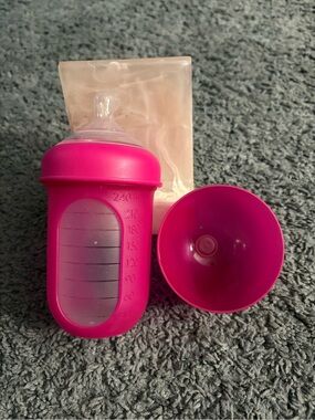 NWOT Boon 8 oz dark pink colored bottle with a lid